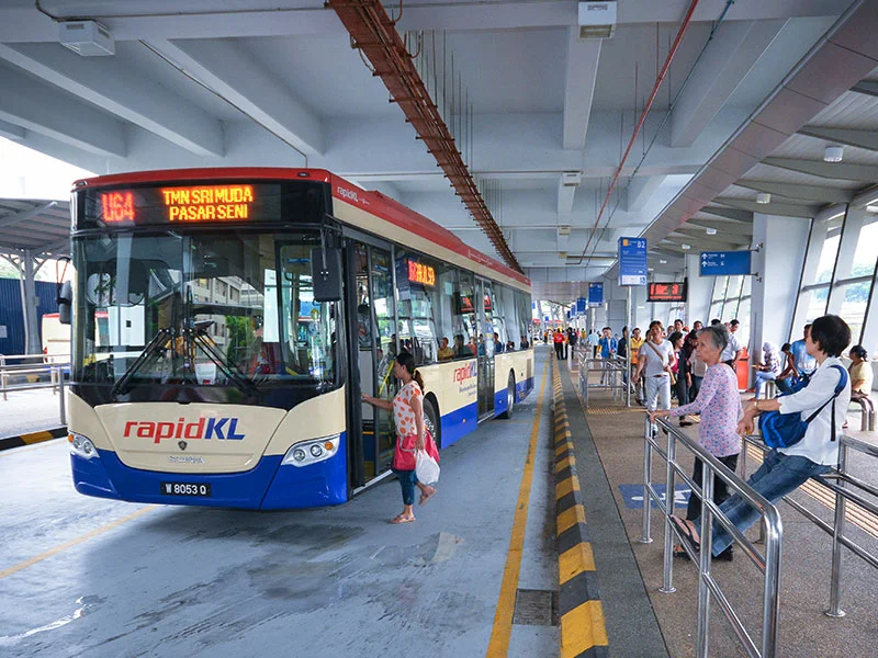Kuala Lumpur Guide - RapidKL Bus at a station with passengers boarding.